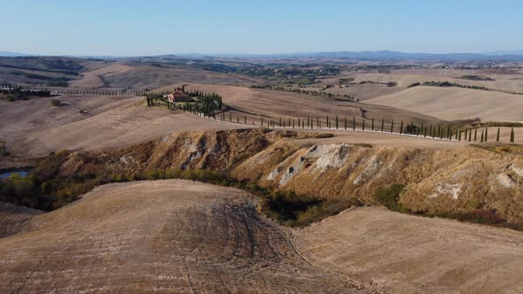 Crete Senesi Tuscan Rolling Hills and Cypress Road Aerial View in Tuscany alt