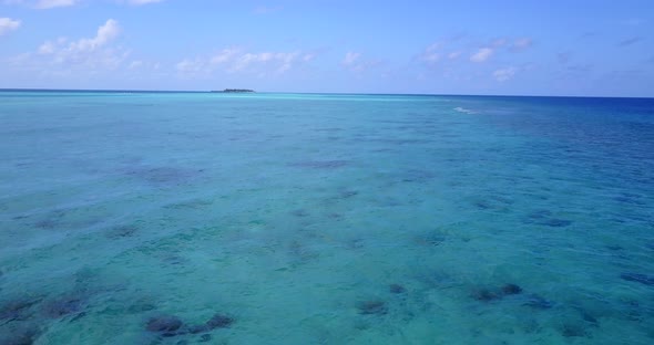 Beautiful aerial tourism shot of a white sandy paradise beach and blue ocean background in vibrant 4 alt