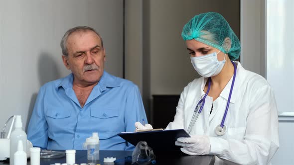 Female Doctor Visiting Sick Senior Man at Home alt