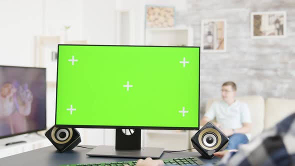 Man Working on Green Screen PC Display in Bright and Modern Flat alt