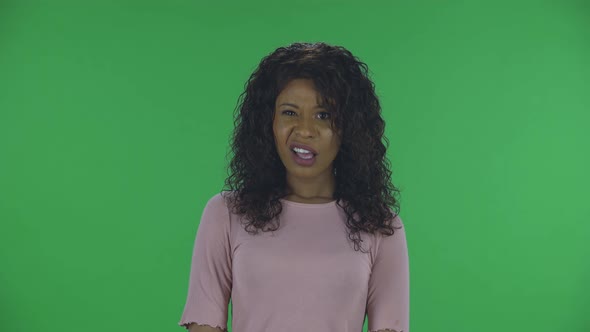 Portrait of Beautiful African American Young Woman Is Looking at Camera in Dislikes. Burning alt