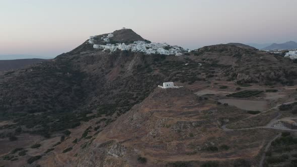 Aerial View Over Island with Church on Hill at Dusk alt