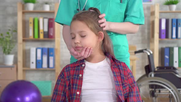 Physical Therapist in Rehab Is Doing the Treatment on the Neck of the Girl Adolescent Close Up alt