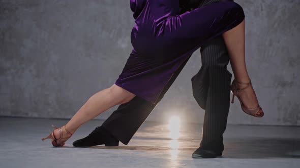 Closeup Shot of Man and Woman Sensually Doing Tango Pose in Grey Studio