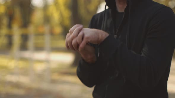 Unrecognizable Sporty Man Warming Up Before Training Outdoors Exercising Locked Wrists Standing in alt