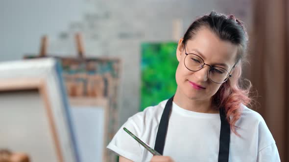 Happy Creative Young Female Painter Focused Working at Art Studio Medium Closeup alt