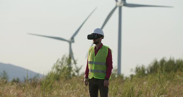 A Young Engineer in VR Glasses Unfolds the Page, Then alt