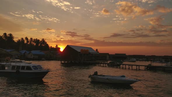 Sunrise sky view at the beach with piers and small boats in an island