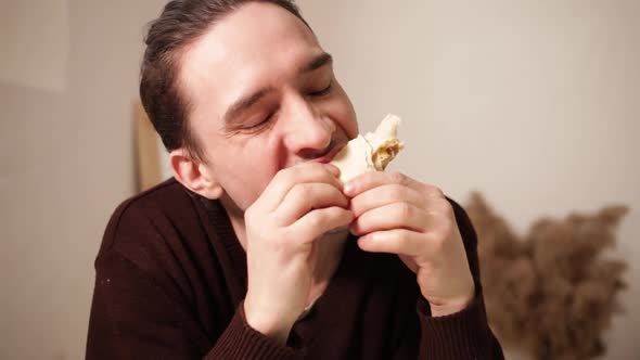 A Man Eats and Enjoys Food
