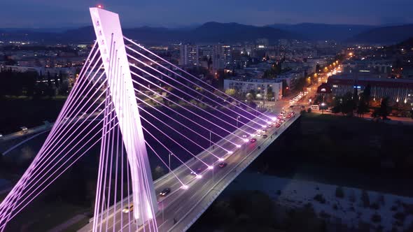 Illuminated cable-stayed bridge at night. Aerial view of Millennium in Podgorica Montenegro. alt