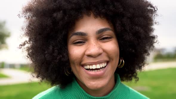 Happy young african woman smiling on camera