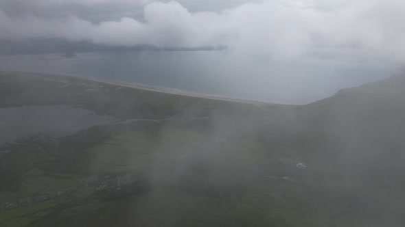 Drone reveal view though clouds Inch beach dingle southwest Atlantic coast, Ireland alt