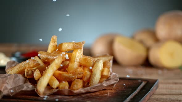 Super Slow Motion Shot of Adding Salt on Fresh French Fries at 1000Fps alt