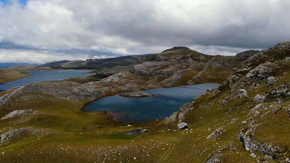 Green Craggy Mountains With Small Ponds At Lagunas De Alto Peru In Sao Paulo, Peru. Tilt-up Shot alt