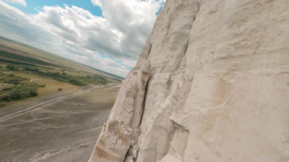 Close Flight Dive on Fpv Drone Around Wonderful White Cliff with Steep Slopes Under Blue Sky with alt