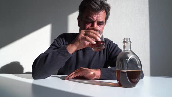 Depressed Mature Man Drinking Alcohol alt
