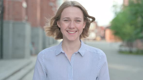 Portrait of Attractive Woman Smiling at Camera Outdoor alt