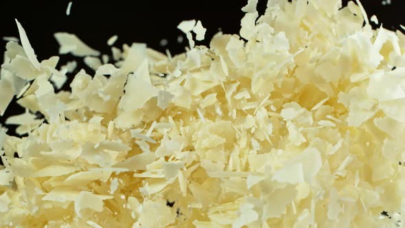 Super Slow Motion Shot of Flying Parmesan Shavings on Black Background at 1000 Fps alt