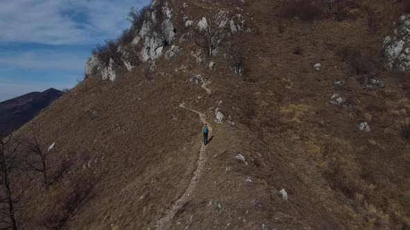 Hiker walking on mountain trail, European Alps, Lecco, Italy