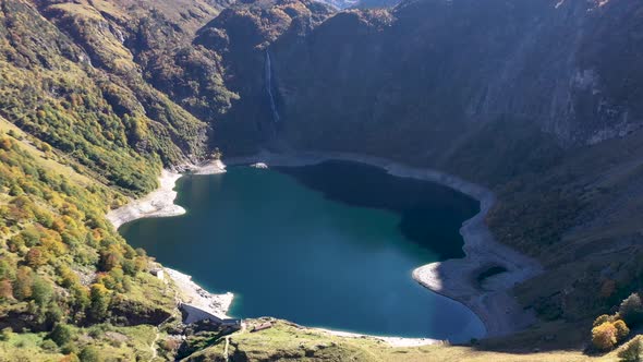 Lac d'Oô lake in the French Pyrenees with low water level and dam wall, Aerial high altitude panoram alt