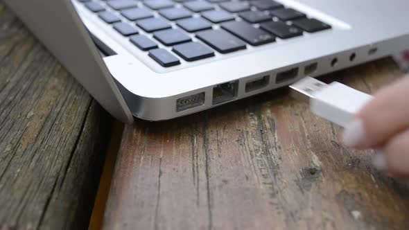 Woman connecting an usb cable