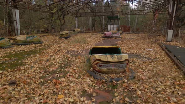 Close Up View of Bumper Cars Decayed Autodrome in Ghost Town Pripyat in Radioactive Chernobyl alt