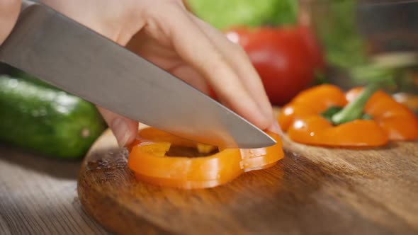 Video Close Up Cutting Orange Bell Pepper Into Small Pieces alt