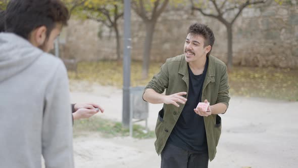 Close Up Shot of Magician Showing Card Trick to the Person on the Street alt