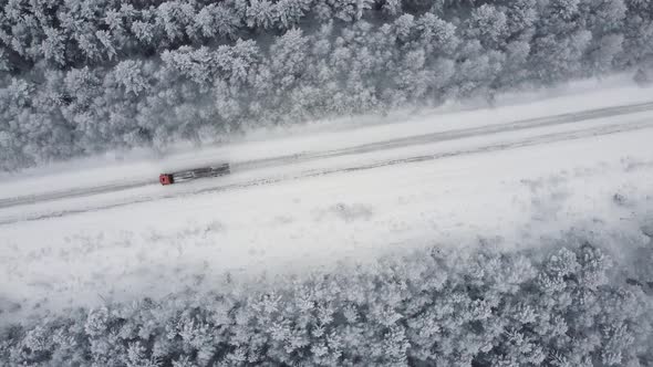 Aerial Top View From Drone Birds Eye View of Winter Landscape and Snowy Ice Road Car Moving on Area