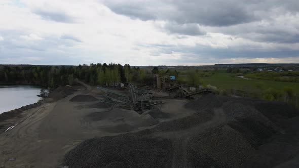 Aerial view basalt quarry of open pit mine machines with sifters and conveyor belts alt