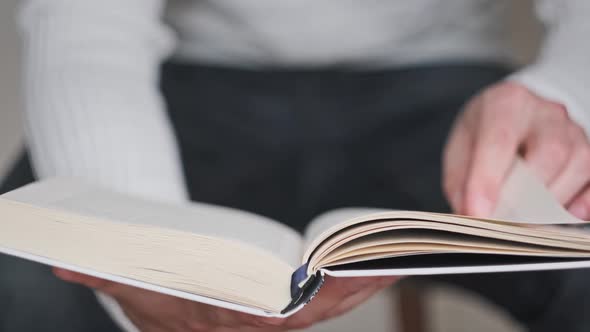 Reading a Book and Turning the Pages Close Up Slow Motion alt