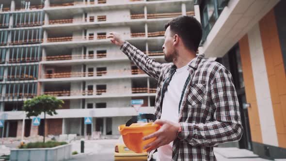 Civil Engineer Giving Instructions To Construction Workers on Construction Site alt