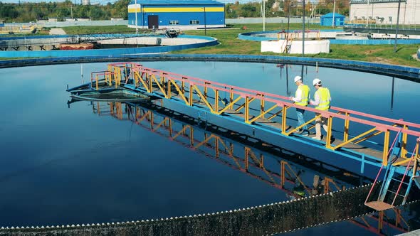 Male Workers Are Observing Processed Wastewaters alt