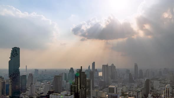 Sunburst or sun rays or god light beam through the cloud over Bangkok city center – Time Lapse