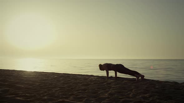 Silhouette Sportswoman Making Plank Pose Practicing Yoga alt