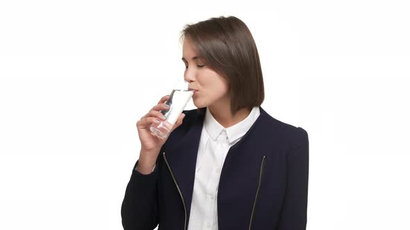 Portrait of Shorthaired Lady Wearing Business Suit Drinking Water From Glass Being Thirsty Taking alt
