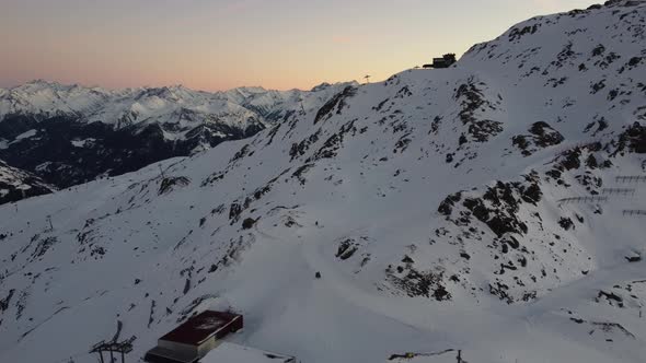 Snowy Mountain Skilifts and Furniculars and Skislopes in Austrian Alps Drone Flyover the Mountains