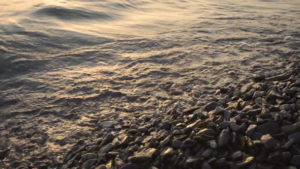 The Waves of the Sea Hit the Pebbles
