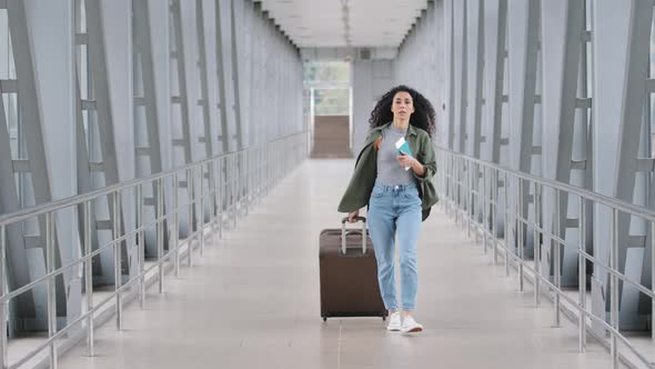 Young Caucasian Lady Girl Woman Female Passenger Tourist Traveler with Suitcase Pushing Carries alt