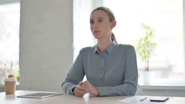 Pensive Woman Thinking While Sitting in Office alt