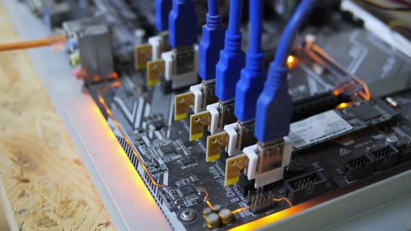 Closeup Cryptocurrency Mining Rig PCIe Riser Extenders Plugged to Motherboard alt