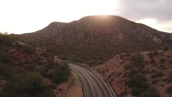 Arizona Desert Road With The Sun Rising Over The Mountains