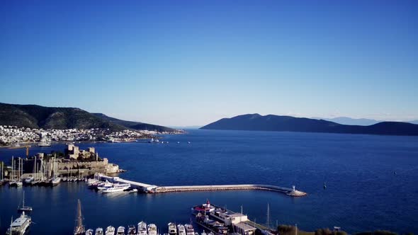 View from drone on full of yachts Bodrum harbour and ancient Kalesi castle in Mugla in Turkey alt