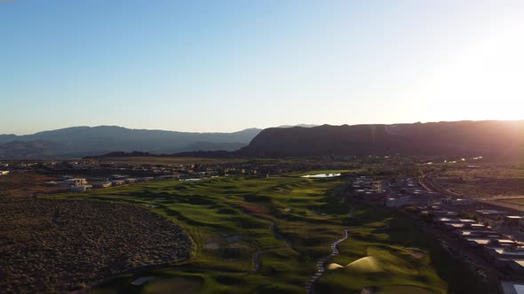 Aerial jib drone flying over the cliff over the sunset. Sunset view of the Ledges golf course in St. alt