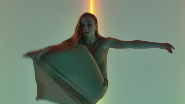 Young and Energetic Woman in a Beige Long Dress Dances Sensual Modern Contempt alt