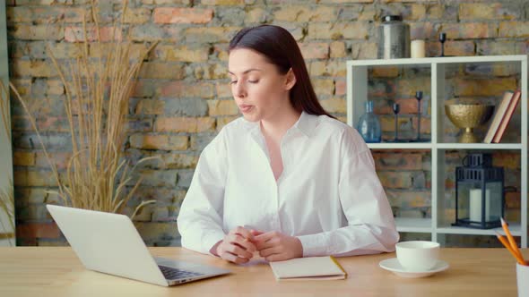 Angry Young Businesswoman Talks to Her Colleague and Throws Away Pencil in Rage alt