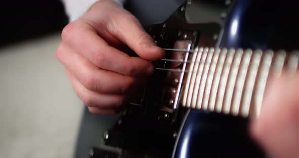 Closeup Creative Musician Playing Fingerpicking with on a Blue Electric Guitar