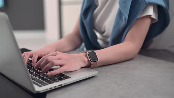 Young Woman Working From Home Remotely Typing on Laptop Keyboard. alt