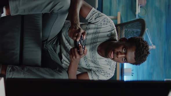 Vertical Video Person Playing Virtual Video Games and Holding Joystick alt