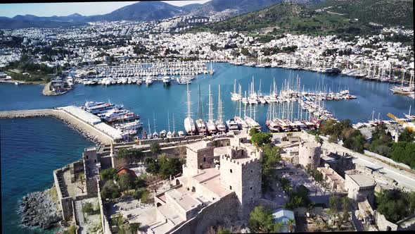 Amazing panoramic view from drone of full of yachts Bodrum harbour and ancient Kalesi castle. alt